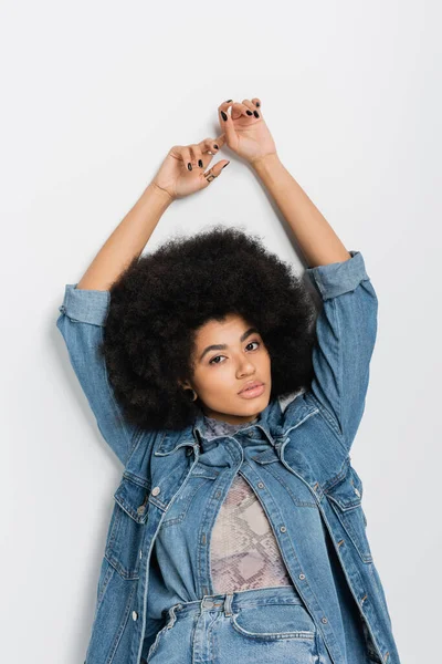 African american woman in denim clothes posing on grey background