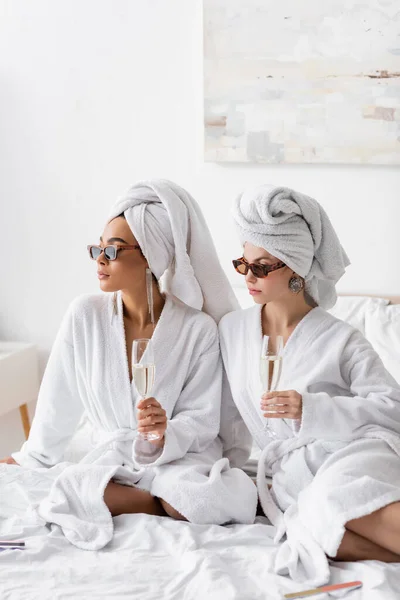 Interracial Women Stylish Sunglasses White Terry Bathrobes Holding Champagne Looking — 스톡 사진