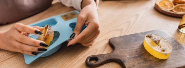 cropped view of african american woman holding silicone mold and handmade soap near chopping board, banner clipart