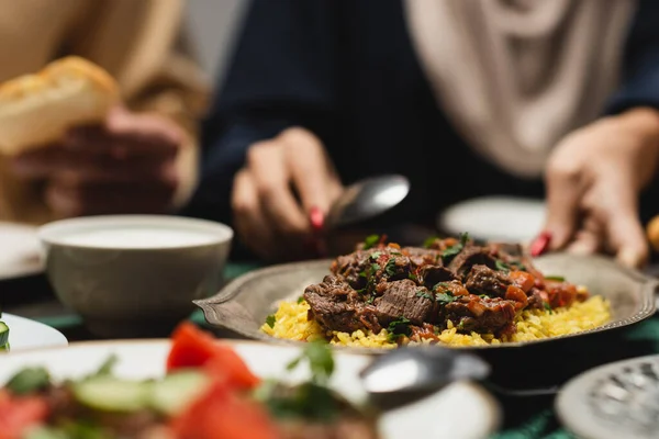 Cropped View Blurred Muslim Woman Putting Pilaf Table Ramadan — 스톡 사진