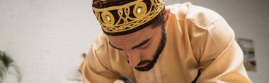 Muslim man praying during ramadan at home, banner 