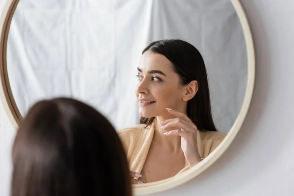 stock image reflection of cheerful woman smiling in bathroom mirror 