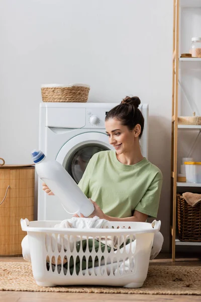Cheerful Brunette Woman Holding Washing Liquid Basket Clothes Laundry Room —  Fotos de Stock