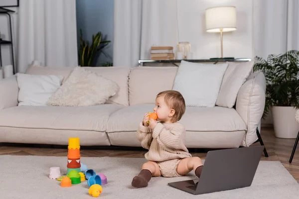 Side View Baby Girl Holding Toy Laptop Living Room — Fotografia de Stock