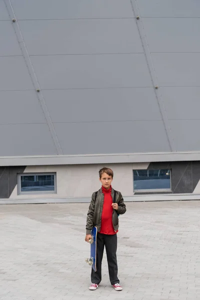 Full Length Preteen Boy Stylish Bomber Jacket Holding Penny Board — Stock fotografie