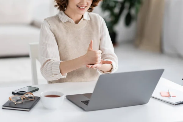 stock image cropped view of cheerful teacher showing help word on sign language during online lesson at home