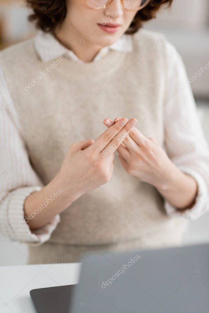Partial view of teacher showing British two handed sign alphabet meaning letter f during online lesson