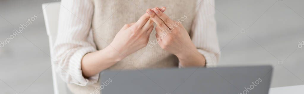 Partial view of teacher showing British two handed sign alphabet meaning letter f during online lesson, banner