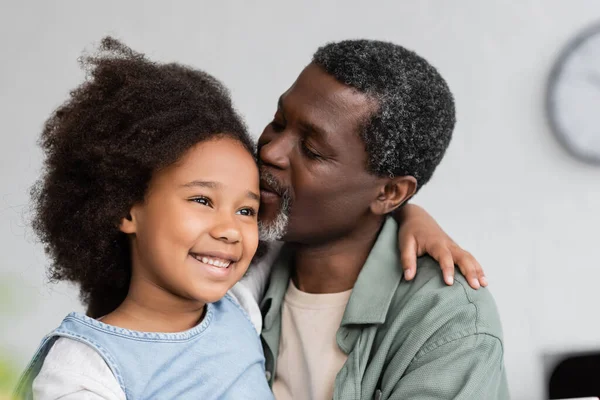African American Grandfather Kissing Head Cheerful Granddaughter Curly Hair — Stock Photo, Image