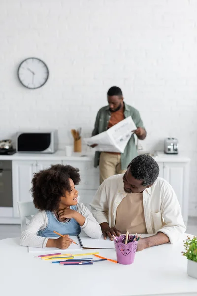 Happy African American Girl Drawing Bearded Grandpa While Father Reading — Stock Photo, Image