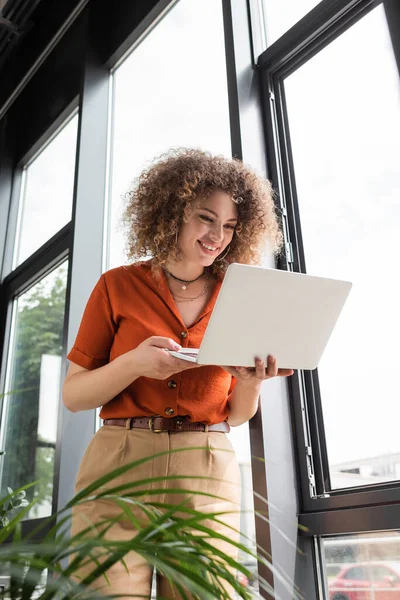 Low Angle View Happy Businesswoman Curly Hair Looking Laptop While — Stock Photo, Image