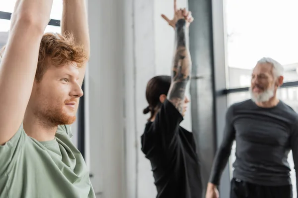 Smiling Redhead Man Standing Crescent Lunge Asana Blurred Group Yoga — Stock Photo, Image