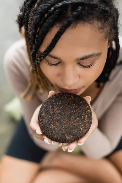 Top View African American Woman Dreadlocks Smelling Compressed Puer Tea — Stock Photo, Image
