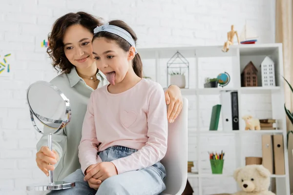 Positive Speech Therapist Holding Mirror Pupil Sticking Out Tongue Consulting — Stock Photo, Image