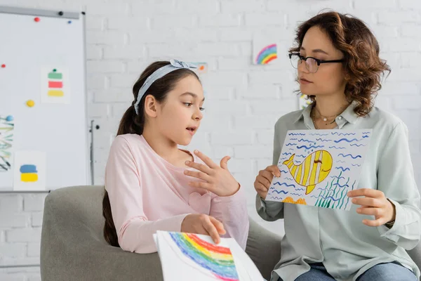 Preteen Criança Falando Enquanto Psicólogo Segurando Desenho Quarto Consultoria — Fotografia de Stock