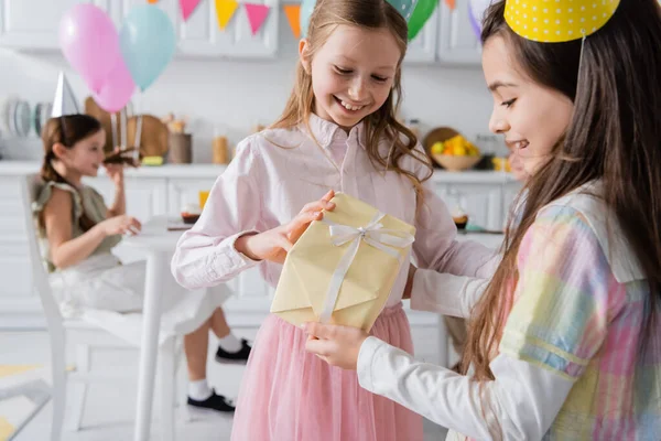 Cheerful Birthday Girl Party Cap Receiving Present Happy Friend — Stock Photo, Image