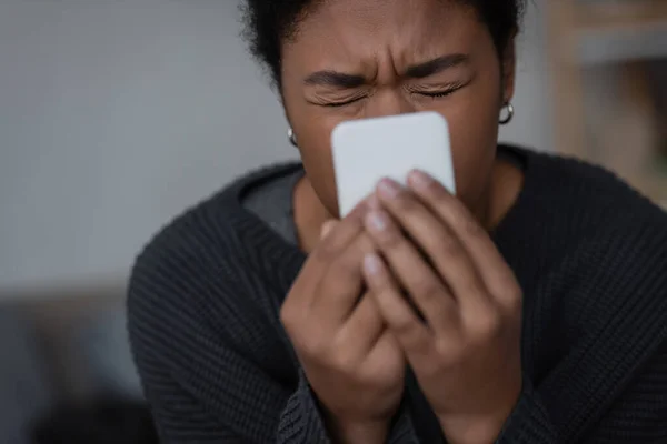 Depressed Multiracial Woman Holding Blurred Smartphone Home — Stock Photo, Image