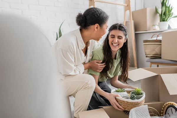 Happy Interracial Lgbt Couple Unpacking Box Laughing New House — Stock Photo, Image