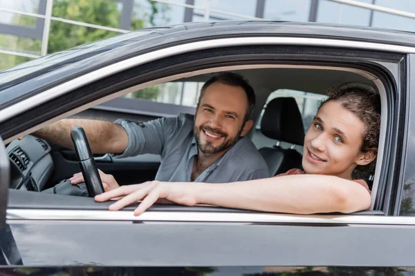 Happy Dad Teenage Son Looking Camera While Sitting Together Car — Stock Photo, Image