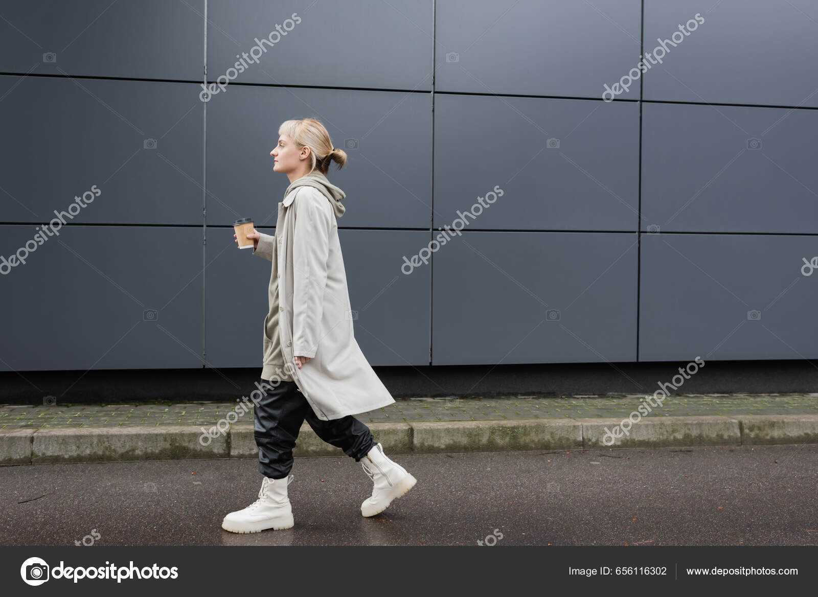 full length of young woman in stylish sunglasses, long hoodie