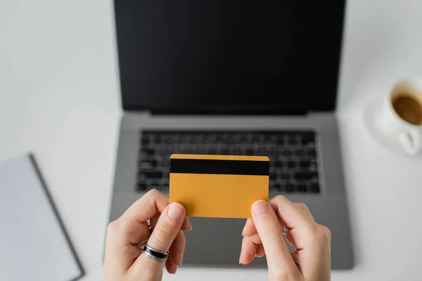 Top View Woman Holding Credit Card Blurred Laptop Blank Screen — Stockfoto