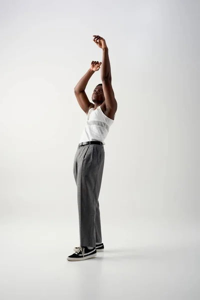 Full Length Trendy Afroamerican Man Sleeveless Shirt Pants Raising Hands — Stock Photo, Image