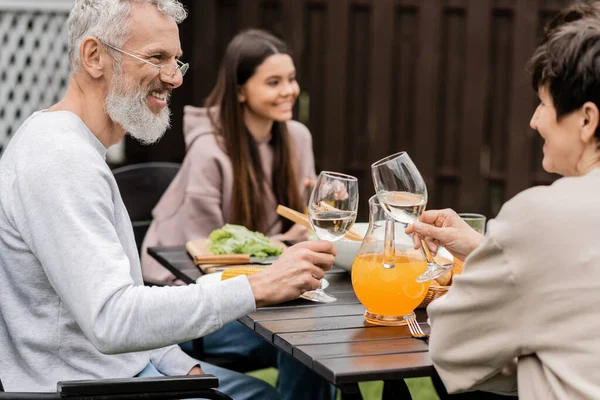 Smiling Mature Parents Clinking Glasses Wine Summer Bbq Food Blurred — Stock Photo, Image