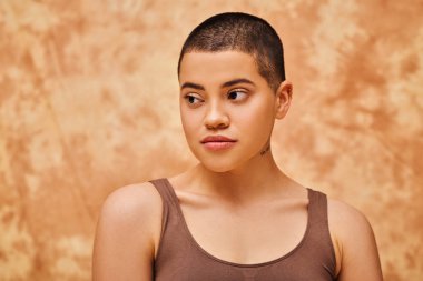 natural beauty, young woman with short hair posing on mottled beige background, individuality, modern generation z, beauty and confidence, body positivity movement, tattooed  clipart
