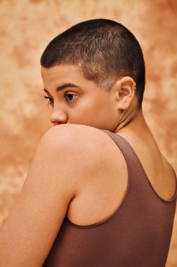 natural look, self-esteem, young woman with short hair posing on mottled beige background, individuality, modern generation z, beauty and confidence, body positivity movement, tattooed  clipart