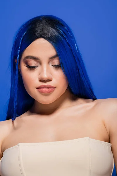 beauty industry, beautiful young woman with dyed hair posing on blue background, hair color, individualism, female model with makeup and trendy hairstyle, vibrant youth, skincare