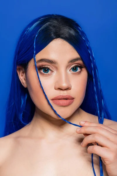 vibrant youth, self expression, portrait of young woman with dyed hair posing on blue background, hair color, individualism, female model with makeup and trendy hairstyle, self expression