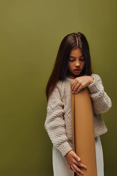时尚的青春期前儿童 头戴舒适的现代针织毛衣 手握滚动纸 孤身一人站在绿色的女孩身上 散发着秋天的气息 — 图库照片