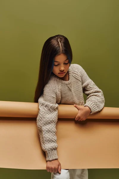 Stylish Brunette Preadolescent Girl Warm Cozy Knitted Sweater Holding Rolled — ストック写真