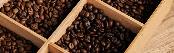 brown coffee beans in wooden box, dark roast, caffeine and energy, coffee background, banner
