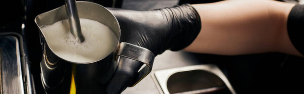 banner, barista foaming milk in pitcher, frothing milk, professional coffee machine, latte 