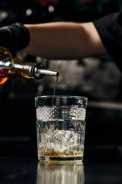 glass with ice, barista preparing ice caramel latte, pouring syrup, summer drink, delicious