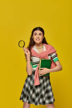 curious young woman holding books and magnifier, zoom, discovery, student in college outfit, smile clipart