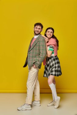 happy students, young woman leaning on man in glasses, college outfits, yellow backdrop, couple clipart