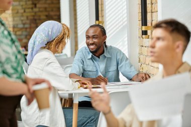 cheerful african american coworkers discussing project over graphs, coworking, start up, ideas clipart