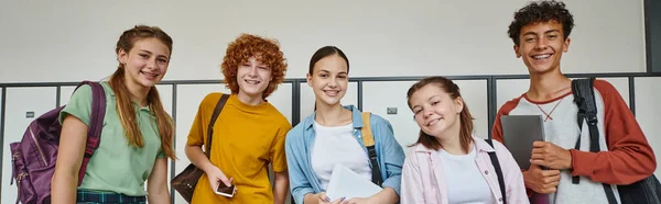 Banner Cheerful Teenage Students Holding Devices Looking Camera School Hallway — Stock Photo, Image