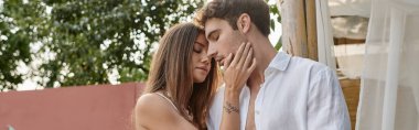 attractive woman touching cheek of boyfriend during summer vacation, before kiss moment, banner clipart