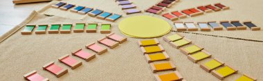 Montessori material, early education school, sun shaped, colorful, natural materials, banner