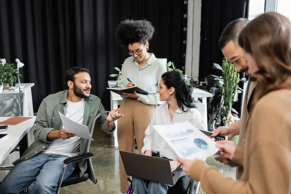 diversity and inclusion, happy multiethnic team planning startup project with woman in wheelchair