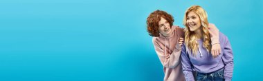 redhead teen boy hugging excited and blonde girlfriend on blue, unity and happiness, banner clipart