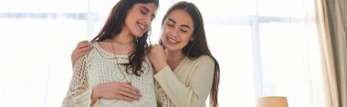 happy lgbt couple hugging warmly with hand on pregnant belly with closed eyes, ivf concept, banner clipart