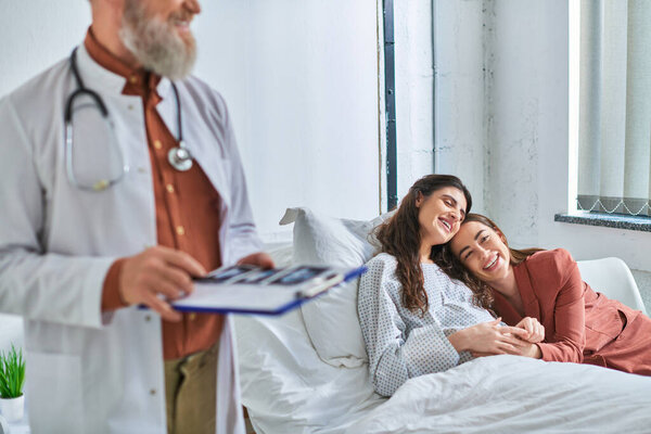 обрезанный взгляд врача проведение ультразвука с объятиями lgbt пара на заднем плане, ivf концепции