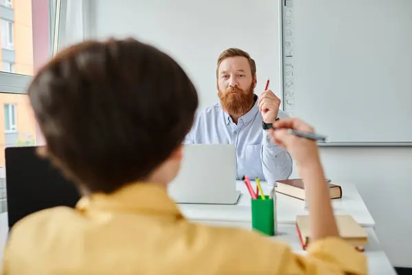Bearded Man Sits Desk Engaged Thought Possibly Preparing Lesson Researching — Stock Photo, Image