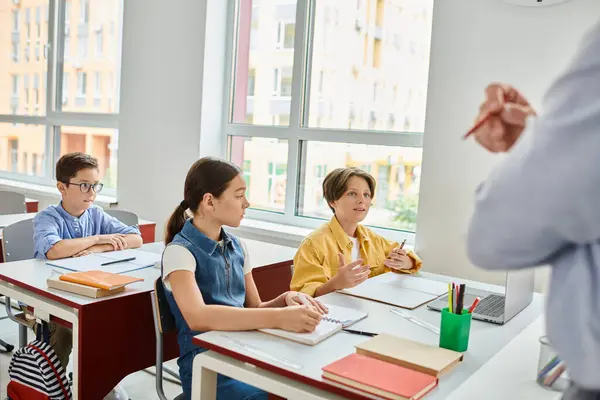 Group Children Engrossed Learning Sit Attentively Desks While Lively Male — Foto de Stock
