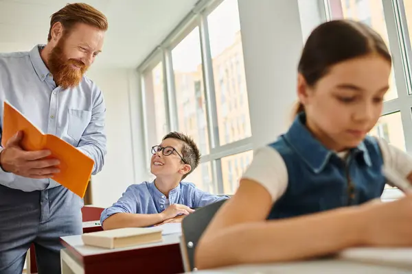 Male Teacher Stands Next Student Lively Classroom Environment Engaging Interactive — Stockfoto