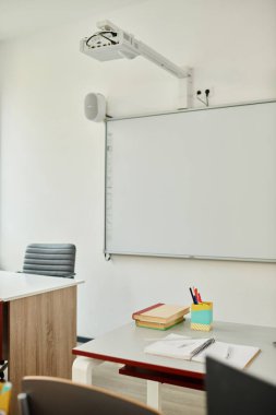 A white board is mounted on a vibrant classroom wall clipart